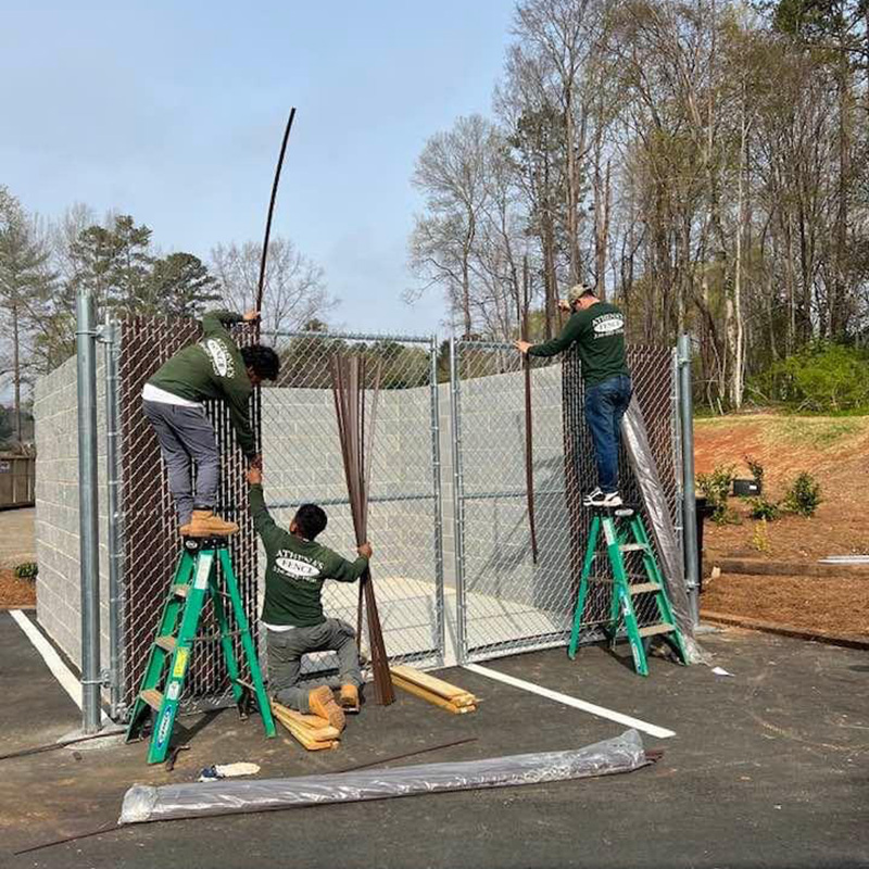 Chain Link Fence Vinyl privacy slats being inserted through fence mesh