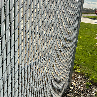 White Vinyl Priavcy Slats in a Chain Link Fence